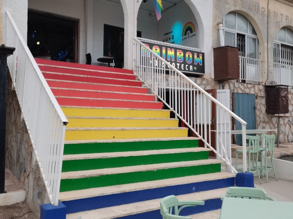 Image of multicoulred steps leading to entrance of the Rainbow bar in La marina